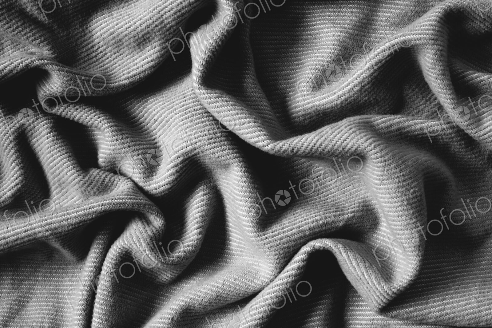 Detail of wrinkles and folds in blanket, overhead view
