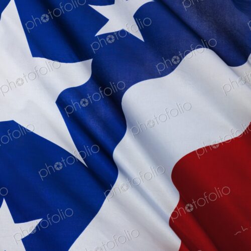Detailed close-up of the United States flag showing stars and stripes in red, white,… Detailed close-up of the United States flag showing stars and stripes in red, white,…