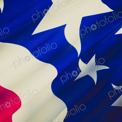 Detailed close-up of the United States flag showing stars and stripes in red, white,… Detailed close-up of the United States flag showing stars and stripes in red, white,…
