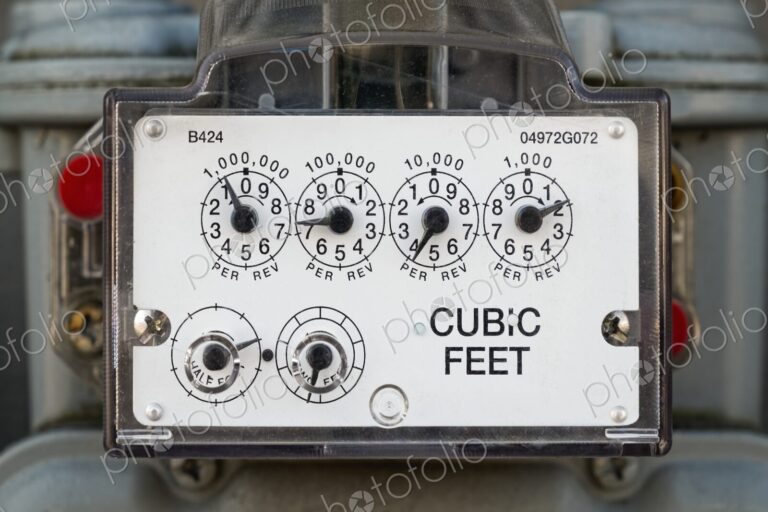 Detailed view of a natural gas meter with dials measuring cubic feet of gas usage for…