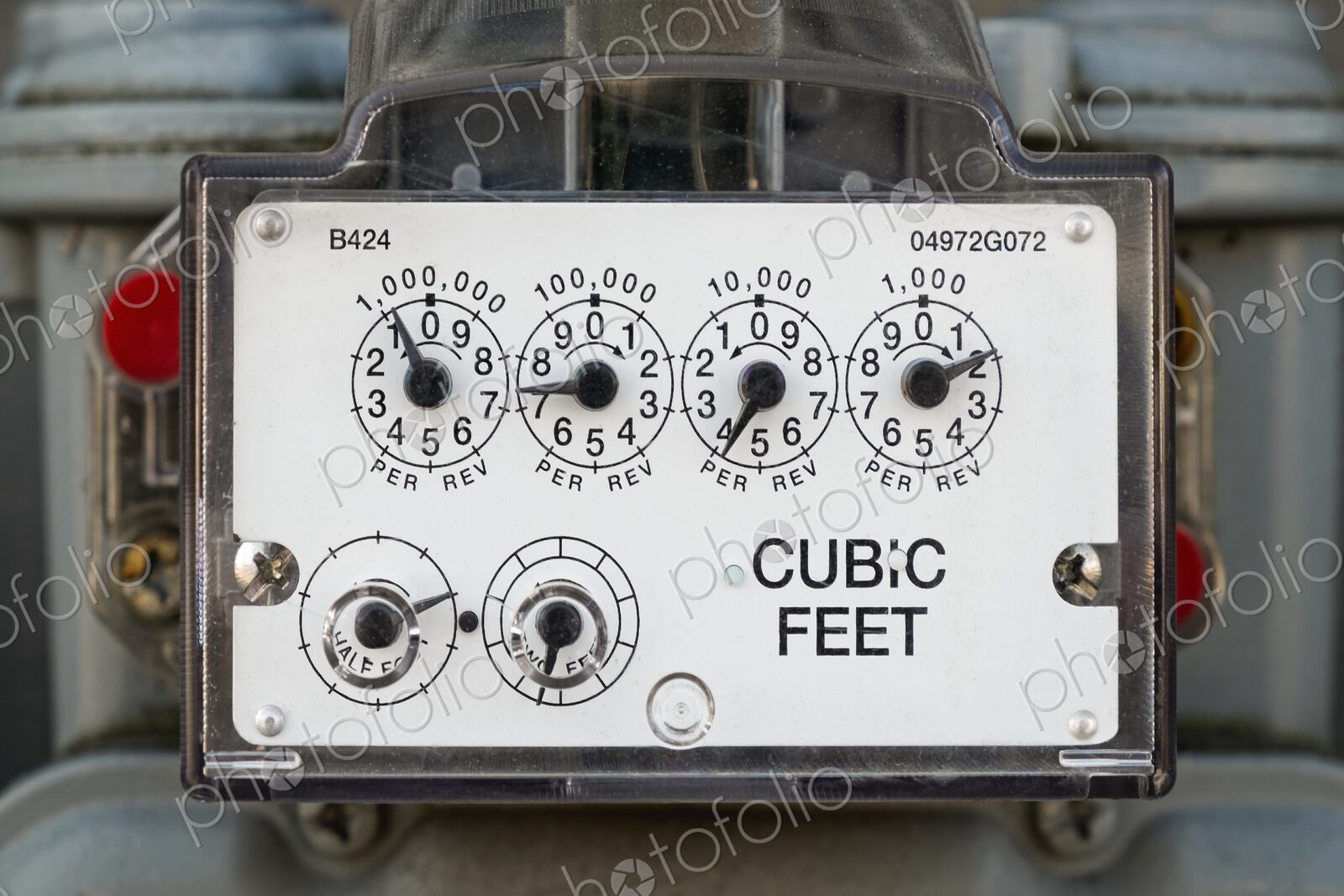 Detailed view of a natural gas meter with dials measuring cubic feet of gas usage for…
