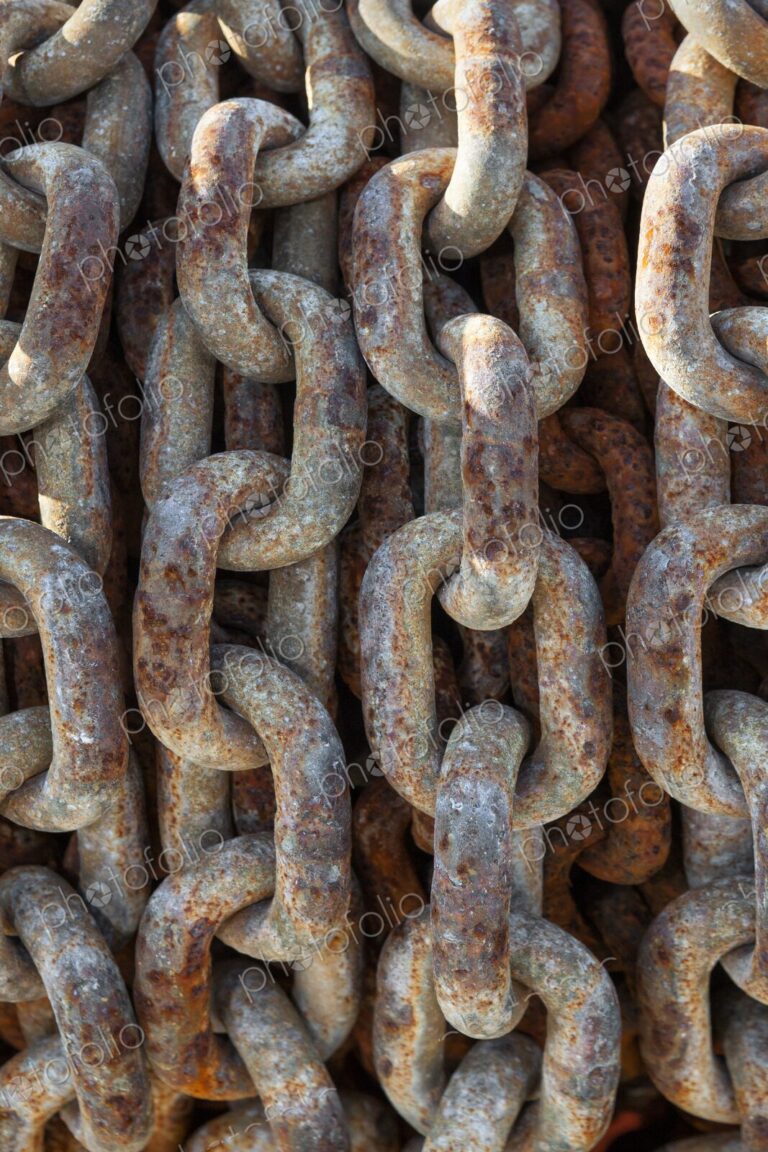 Detailed view of an old, rusted chain at Charleston Marina, Oregon, highlighting…