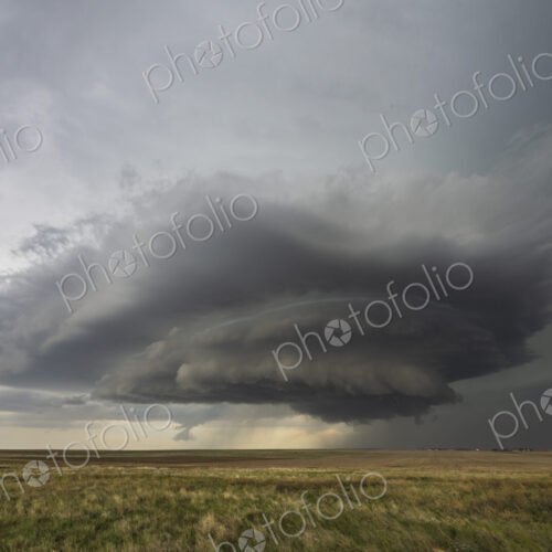 Developing Mesocyclone, a towering cloud shape above the horizon, fields. Developing Mesocyclone, a towering cloud shape above the horizon, fields.