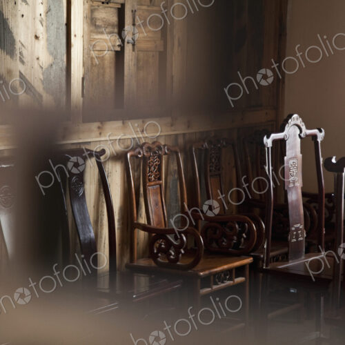 Dining chairs in wooden panelled room.