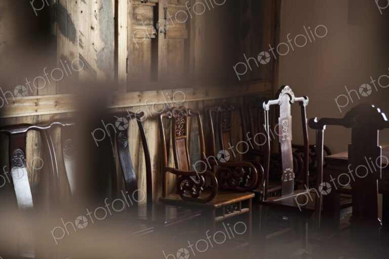 Dining chairs in wooden panelled room.
