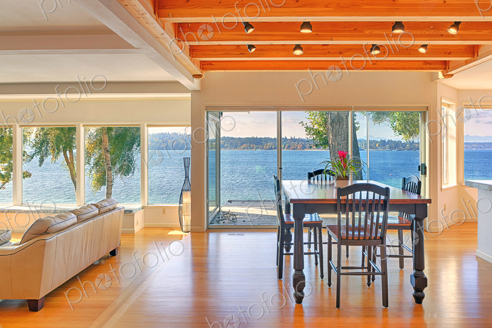 Dining table, sofa and glass walls in modern house