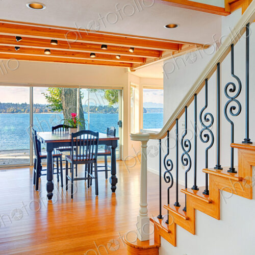Dining table, staircase and glass walls in modern house