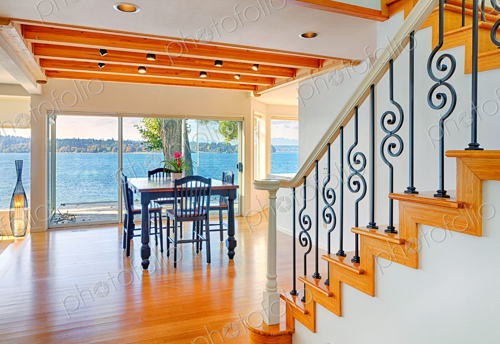 Dining table, staircase and glass walls in modern house