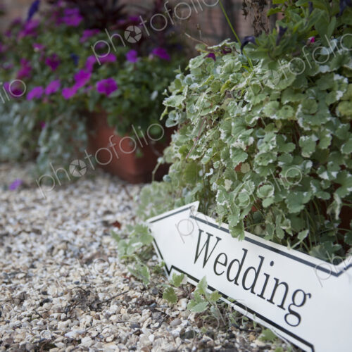 Directional sign to a wedding, on a gravel path. Directional sign to a wedding, on a gravel path.