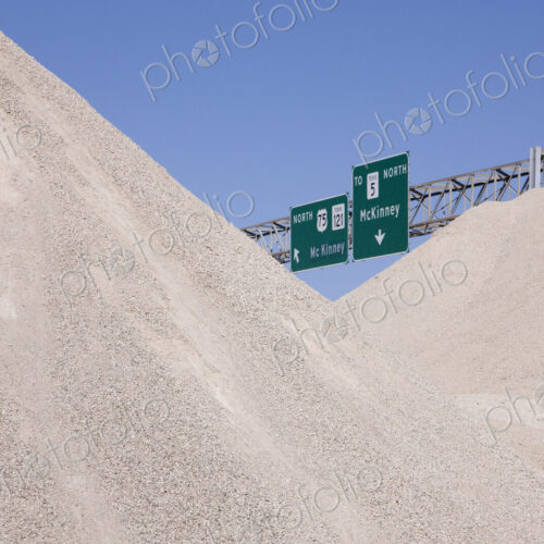 Dirt Mounds with Highway Signs in Background Dirt Mounds with Highway Signs in Background