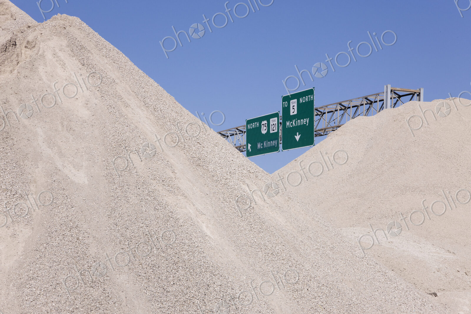 Dirt Mounds with Highway Signs in Background