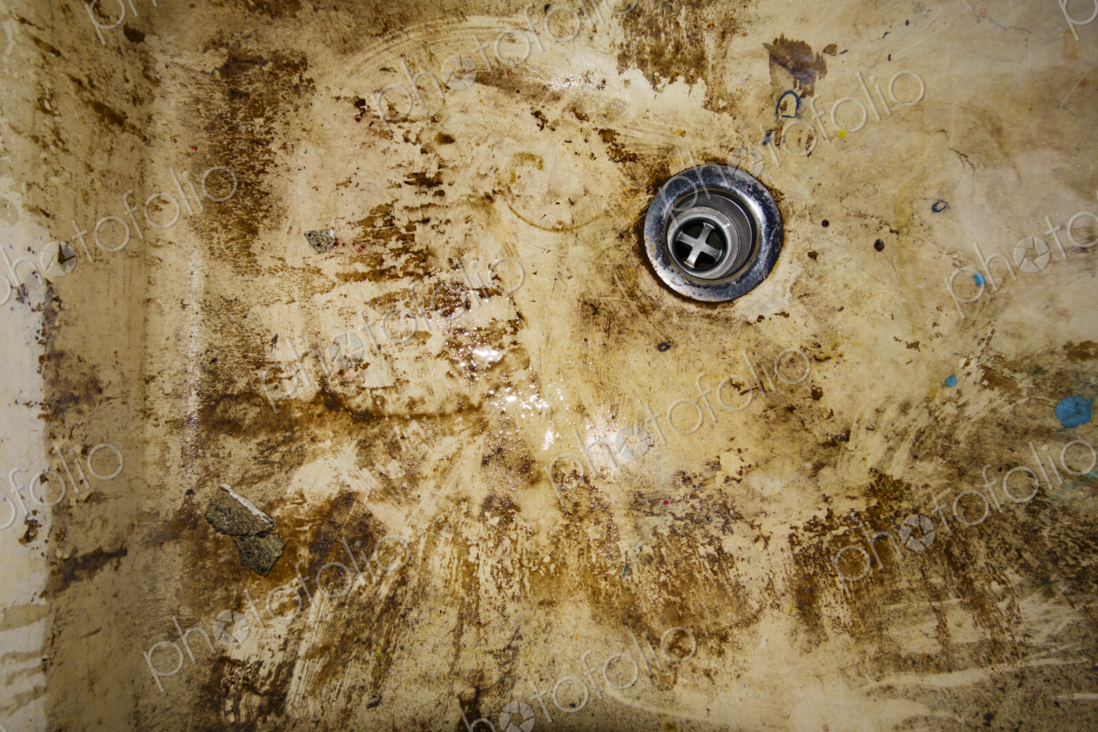 Dirty sink drain, muddy basin.