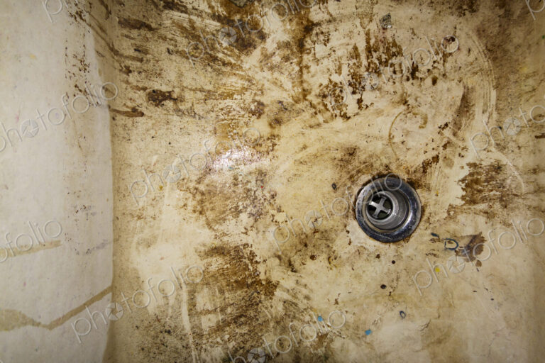 Dirty sink drain, muddy basin.