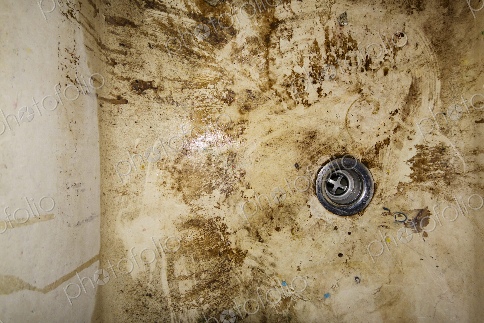 Dirty sink drain, muddy basin.