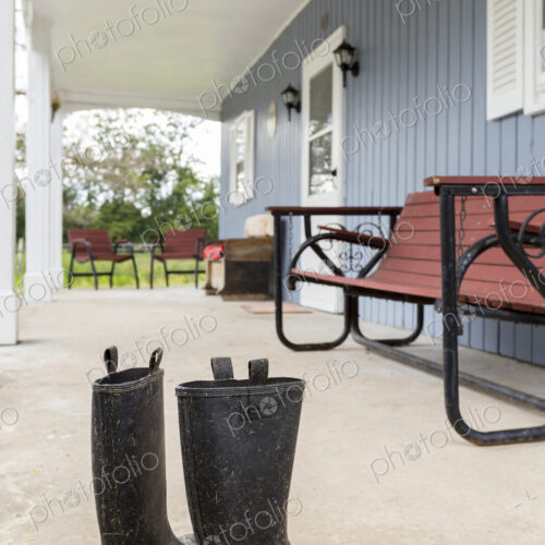 Dirty wellingtons on front porch
