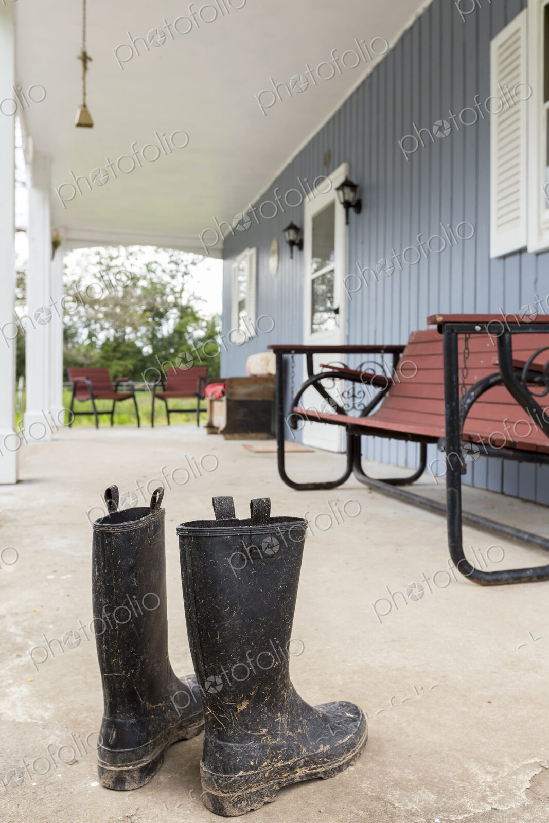 Dirty wellingtons on front porch