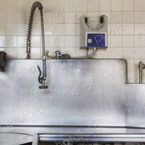 Dishwashing Station with stainless steel surfaces in large catering kitchen Dishwashing Station with stainless steel surfaces in large catering kitchen