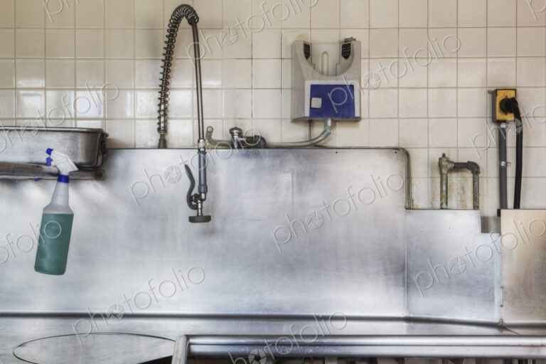 Dishwashing Station with stainless steel surfaces in large catering kitchen