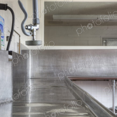 Dishwashing Station with stainless steel surfaces in large catering kitchen Dishwashing Station with stainless steel surfaces in large catering kitchen