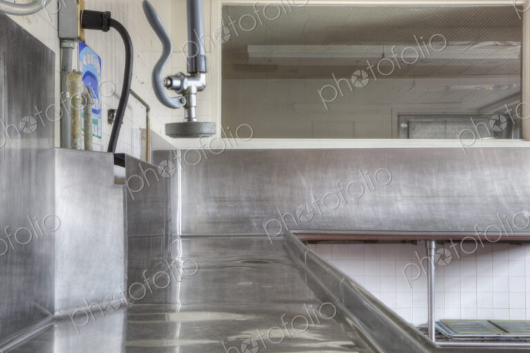 Dishwashing Station with stainless steel surfaces in large catering kitchen