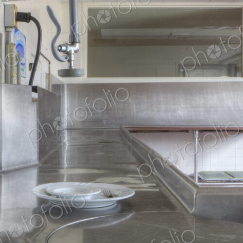 Dishwashing Station with stainless steel surfaces in large catering kitchen Dishwashing Station with stainless steel surfaces in large catering kitchen