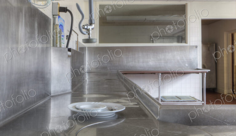 Dishwashing Station with stainless steel surfaces in large catering kitchen