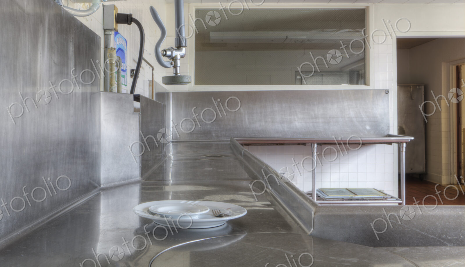 Dishwashing Station with stainless steel surfaces in large catering kitchen