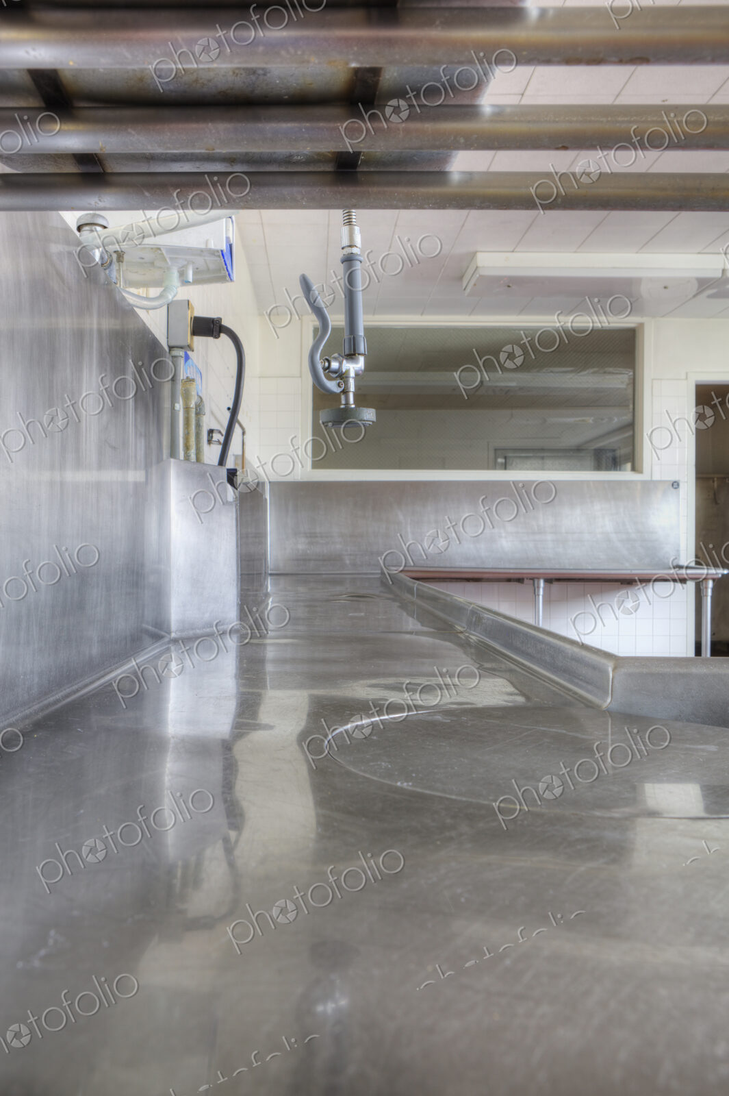 Dishwashing Station with stainless steel surfaces in large catering kitchen