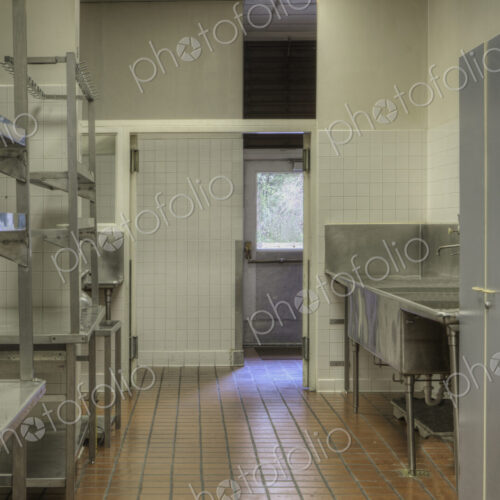 Dishwashing Station with stainless steel surfaces in large catering kitchen Dishwashing Station with stainless steel surfaces in large catering kitchen