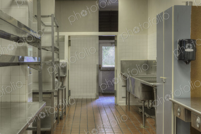 Dishwashing Station with stainless steel surfaces in large catering kitchen