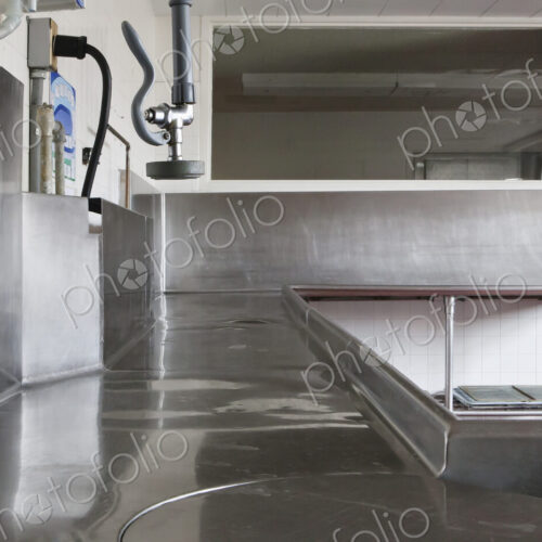 Dishwashing Station with stainless steel surfaces in large catering kitchen