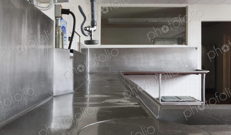 Dishwashing Station with stainless steel surfaces in large catering kitchen