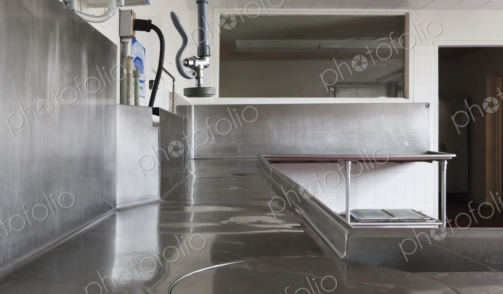 Dishwashing Station with stainless steel surfaces in large catering kitchen