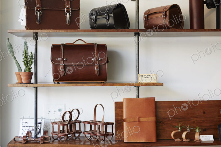 Display of leather goods on shelves. Briefcases and bags.