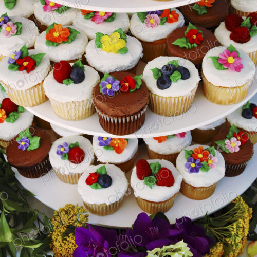 Display stand with decorated floral cupcakes Display stand with decorated floral cupcakes
