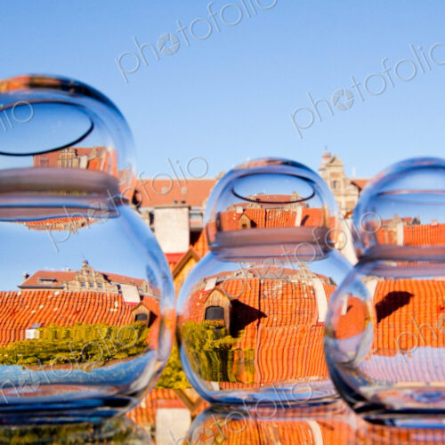 Distorted view through clear water in jars of the rooftops of the city. Distorted view through clear water in jars of the rooftops of the city.