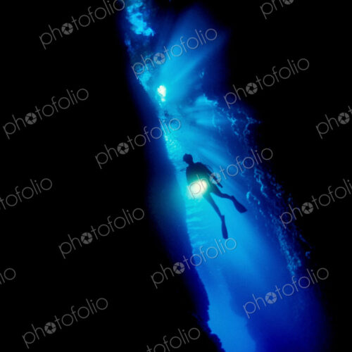 Diver silhouetted against the entrance to an underwater cave, Solomon Islands. Diver silhouetted against the entrance to an underwater cave, Solomon Islands.
