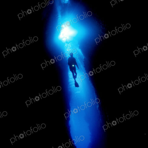 Diver silhouetted against the entrance to an underwater cave, Solomon Islands. Diver silhouetted against the entrance to an underwater cave, Solomon Islands.