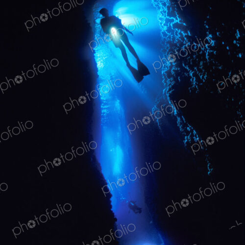 Diver silhouetted against the entrance to an underwater cave, Solomon Islands. Diver silhouetted against the entrance to an underwater cave, Solomon Islands.