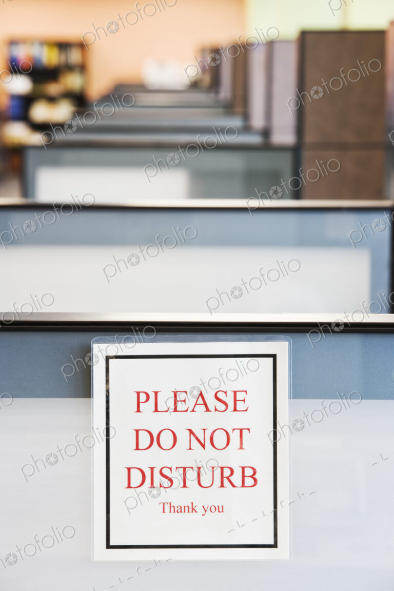 Do not disturb sign hung on the wall of a cubicle in an office.