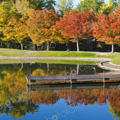 Dock on calm lake in autumn Dock on calm lake in autumn