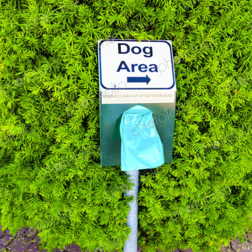 Dog Poop disposal bag dispenser, in a public park. Dog Poop disposal bag dispenser, in a public park.
