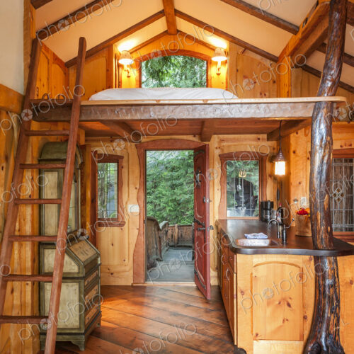 Doorway and loft bedroom in wooden tree house