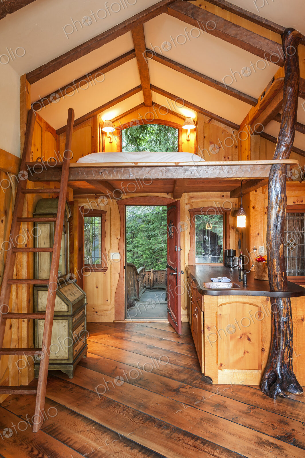 Doorway and loft bedroom in wooden tree house