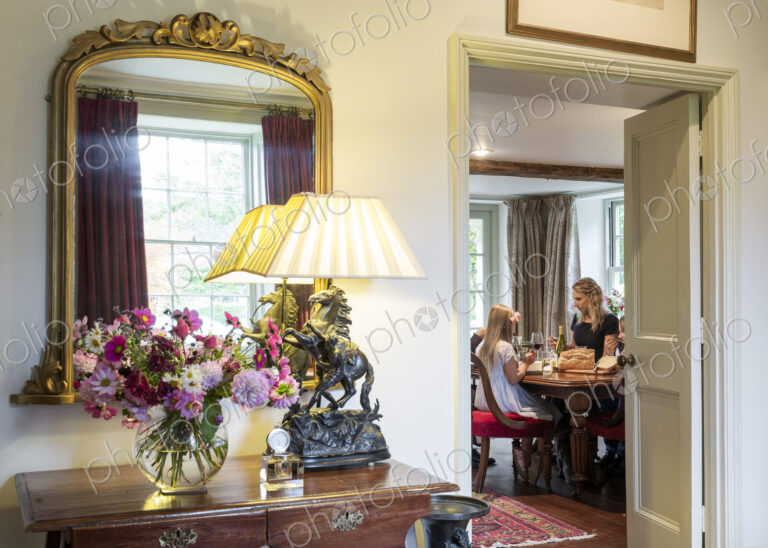 Doorway to Caucasian mother and daughter eating in dining room