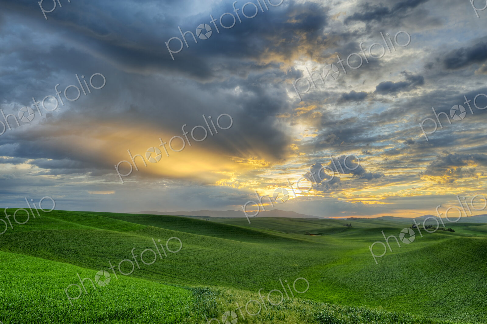 Dramatic sky over rolling hills in rural landscape