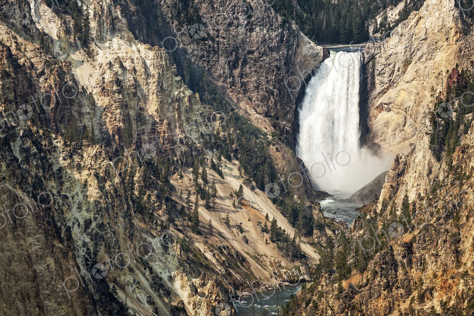 Dramatic view of Lower Falls in Yellowstone National Park, Wyoming, with rugged canyon…