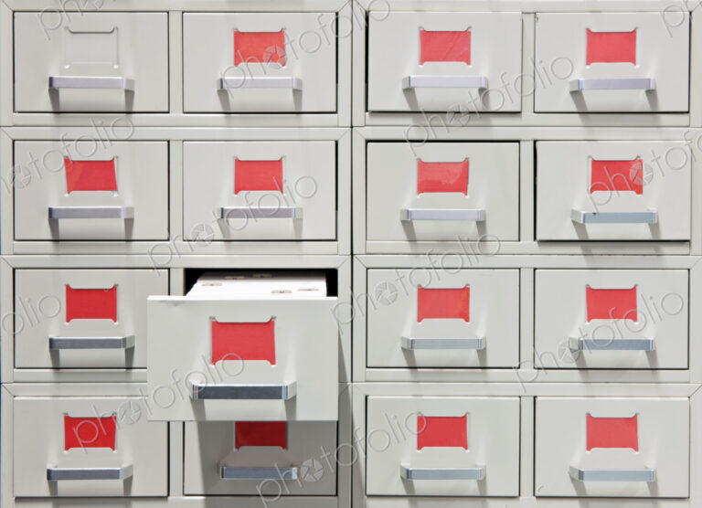 Drawers and red labels in an antique archive cabinet with index cards in a public library