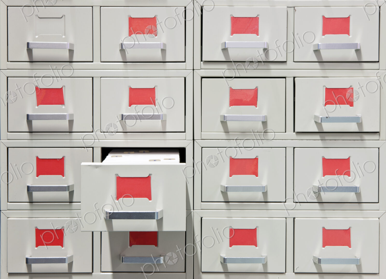 Drawers and red labels in an antique archive cabinet with index cards in a public library