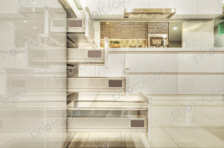 Drawers in a modern fitted kitchen with white doors and surfaces.